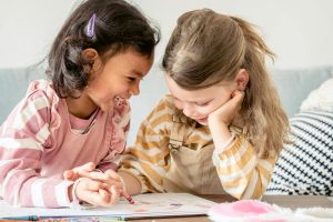 happy diverse girls painting together